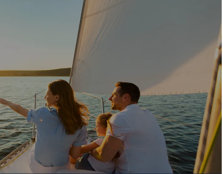 Family sailing at sunset